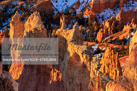 Rocks and hoodoos lit by strong dawn light in winter, Queen's Garden Trail at Sunrise Point, Bryce Canyon National Park, Utah, United States of America, North America