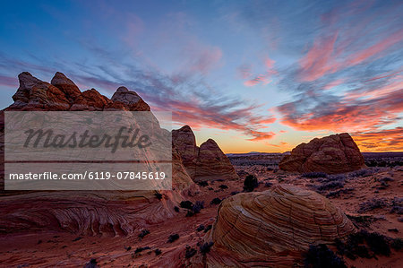 Orange clouds over sandstone cones, Coyote Buttes Wilderness, Vermilion Cliffs National Monument, Arizona, United States of America, North America