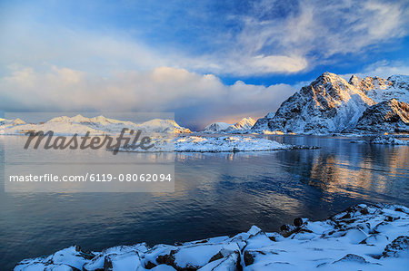 The feeble light of the sunset on a fjord near Henningsvaer covered in snow, Lofoten Islands, Arctic, Norway, Scandinavia, Europe