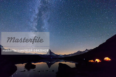 Camping under the stars and Milky Way with Matterhorn reflected in Lake Stellisee, Zermatt, Canton of Valais, Swiss Alps, Switzerland, Europe