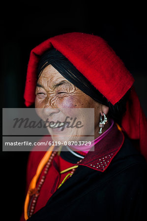 An Chinese Ngawa woman wearing traditionally bright dress in Songpa, Sichuan, China, Asia