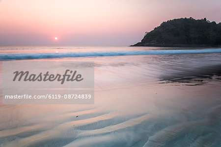 The sunset is reflected on the Beach of Masua, Iglesias, iglesias wave 
