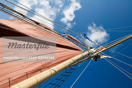 Red sails on sailboat that takes tourists out for sunset cruise, Key West, Florida, United States of America, North America