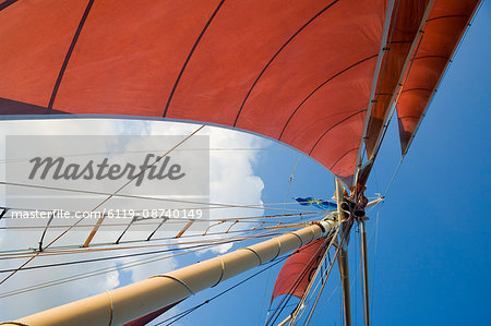 Red sails on sailboat that takes tourists out for sunset cruise, Key West, Florida, United States of America, North America