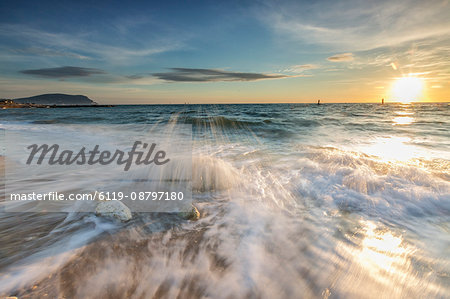 Waves crashing on the sandy beach framed by sunrise, Porto Recanati, Province of Macerata, Conero Riviera, Marche, Italy, Europe