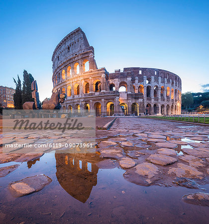 The Colosseum (Flavian Amphitheatre), UNESCO World Heritage Site, reflected in a puddle at dusk, Rome, Lazio, Italy, Europe