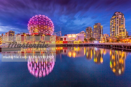 View of False Creek and Vancouver skyline, including World of Science Dome at dusk, Vancouver, British Columbia, Canada, North America