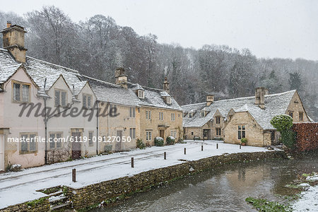 Snow covered houses by By Brook in Castle Combe, Wiltshire, England, United Kingdom, Europe