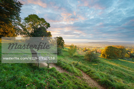 Cotswold Way path and bench with views to the Malvern Hills at sunset, Ford, Cotswolds, Gloucestershire, England, United Kingdom, Europe