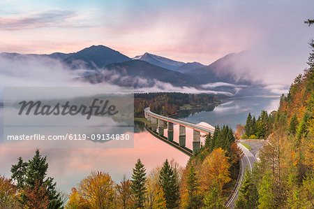 Sylvenstein Lake and bridge surrounded by the morning mist at dawn, Bad Tolz-Wolfratshausen district, Bavaria, Germany, Europe