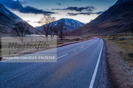 View of road through the Glencoe Valley at dusk, Glencoe, Highland Region, Scotland, United Kingdom, Europe
