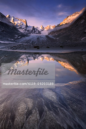 Sunrise reflected in a pond at Forno Glacier, Forno Valley, Maloja Pass, Engadine, Graubunden, Switzerland, Europe