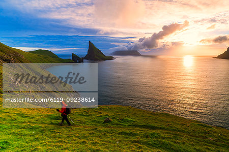 Trekker on the hiking trail to Drangarnir rock, Vagar island, Faroe Islands, Denmark, Europe