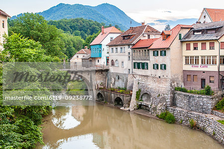 Houses lining a river, Skofja Loka village, near Ljubljana, Slovenia, Europe