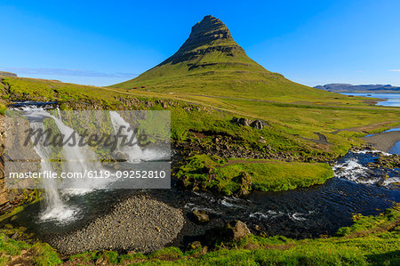 Kirkjufellsfoss waterfall and Kirkjufell mountain in Grundarfjordur, Iceland, Europe