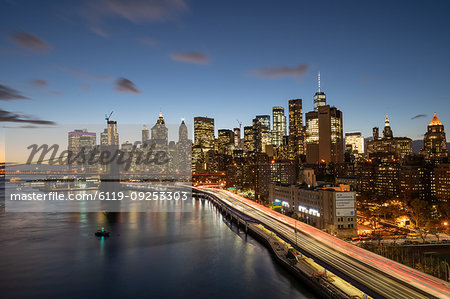 The lights of Lower Manhattan at dusk viewed from the Manhattan Bridge, New York, United States of America, North America