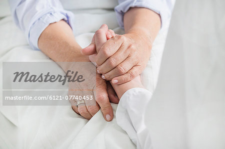 Woman holding patient's hand Woman holding patient's hand