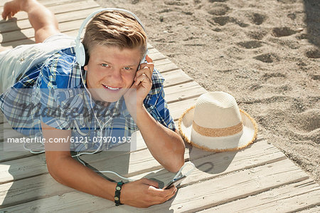 Boy beach summer headphones listening music Boy beach summer headphones listening music