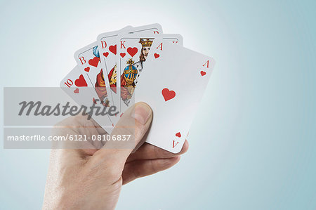 Close-up of man's hand holding playing cards, Bavaria, Germany Close-up of man's hand holding playing cards, Bavaria, Germany