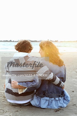 A couple watching the sunset at a beach