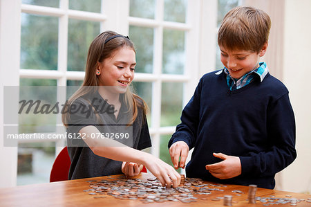 Children counting piles of coins