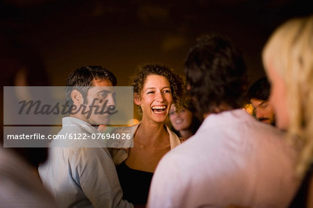 Woman laughing at party at night