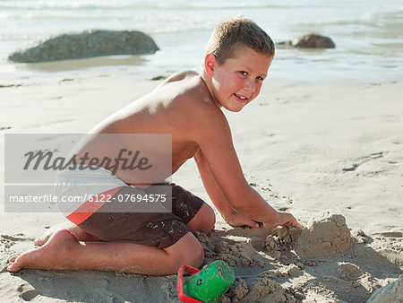 Boy making sandcastles on a beach