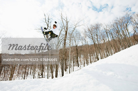 Snowboarder jumping in midair