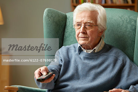 Senior man using remote control