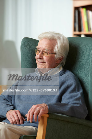 Senior man in armchair, portrait