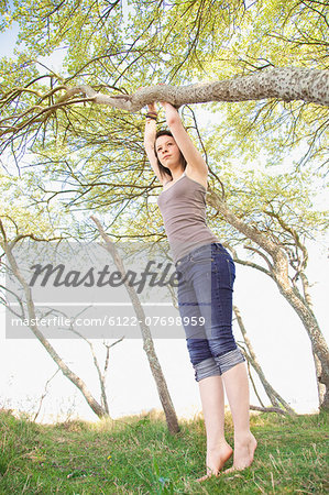 Girl climbing tree outdoors