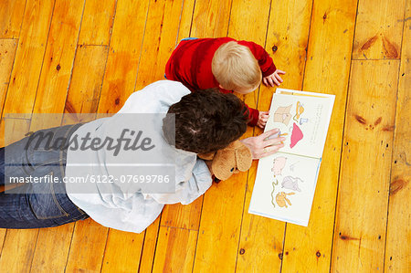 Father and son reading together