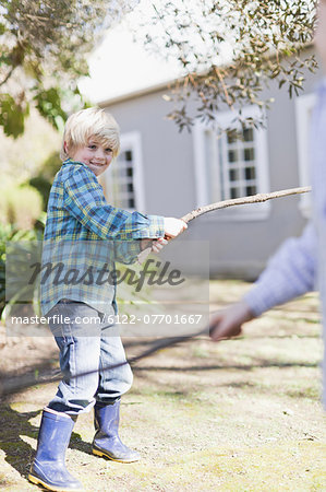 Children playing with sticks outdoors