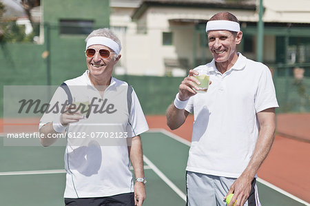 Older men drinking lemonade on court