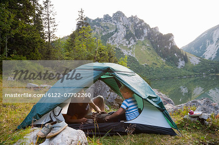 Father and son relaxing in tent
