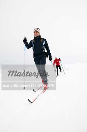 Couple cross-country skiing in snow