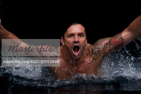 Man splashing in swimming pool