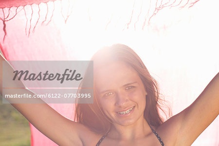 Teenage girl in braces holding sarong