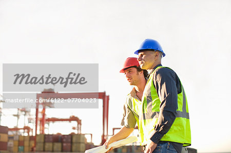 Construction workers talking on site