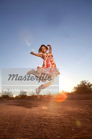 Woman jumping for joy in desert