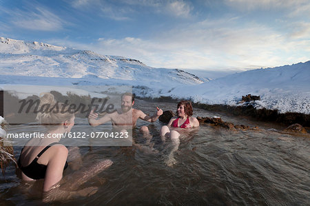 Friends relaxing in glacial hot spring