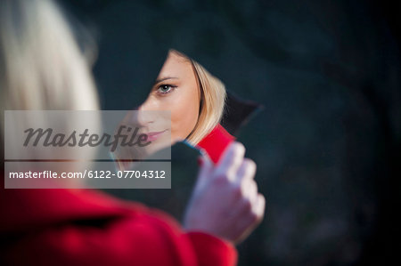 Woman admiring herself in mirror shard
