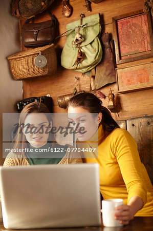 Women using laptop in cafe