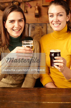 Women drinking beer in pub