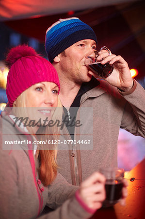 Couple having coffee outdoors in winter