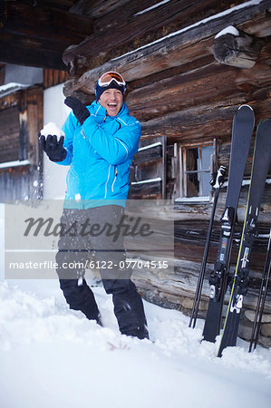 Man throwing snowball outdoors