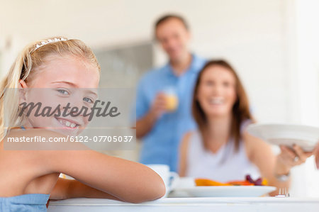 Smiling girl sitting at table