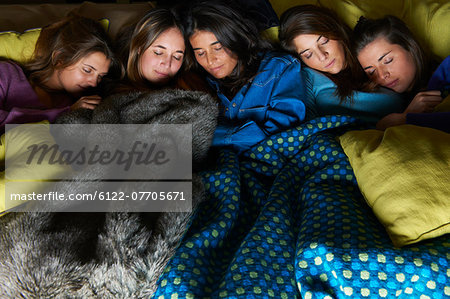 Women sleeping in bed together