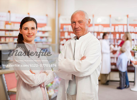 Smiling pharmacists standing in store