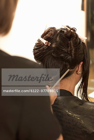 Hair stylist working on clients hair
